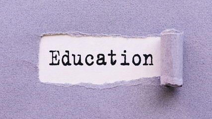 The text EDUCATION appears on torn lilac paper against a white background.