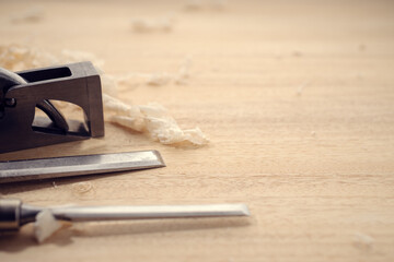 Carpentry or woodworking background with copy space. Carpentry tools and wood shavings on a table