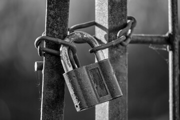 old lock closing metal door, black and white shot