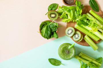 Obraz premium Healthy diet and nutrition, vegan, alkaline, vegetarian concepts. Green smoothie with celery, kiwi and spinach on a green pink background. Top view flat lay. Copy space.