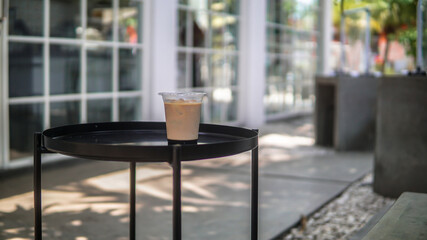 Ice coffee with plastic cup at outdoor cafe 