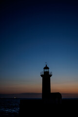 Lighthouse in sunset in front of sea