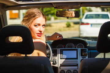 Woman in car looking back