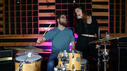 music group rehearsing, testing vocals and mastering in a professional recording studio