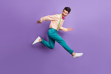 Fototapeta na wymiar Full length profile side photo of gentleman jump run empty space wear blue pants isolated on violet color background