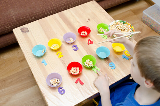 Little child doing simple math exercises. Early education, counting game. Preschool exercise for kids. Sequence from 1 to 10. Montessori math tool. 