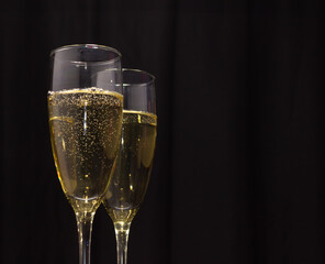 Champagne glasses on a dark background. The concept of the celebration.