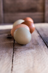 Farm fresh eggs lined up on wooden farm table