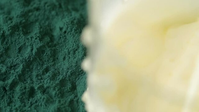 glass of milk with spirulina powder view from top