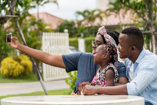 American African  black mother take mobile photo selfie family with smile and happy in garden house- American African family outdoor activity moments