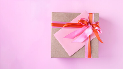 Gift box and envelope with bright ribbon on a pink background. Concept for Valentine's Day, Mother's Day or Birthday. With place for text. Ещз мшуц