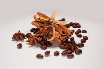 Cinnamon sticks, star anise and coffee on white background