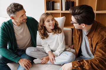Happy caucasian gay couple smiling and talking with their daughter