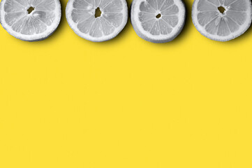 gray lemon slices on a yellow background 