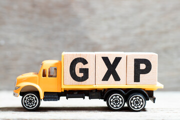 Truck hold letter block in word GXP on wood background