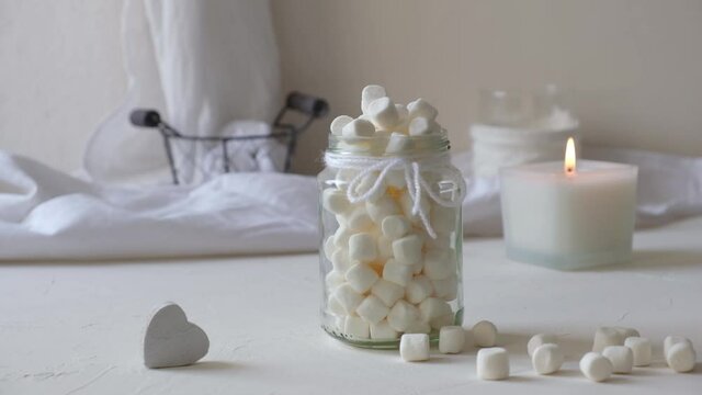 Marshmallows in a glass on a white table