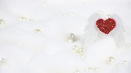 Valentines day romantic heart with angel wings with white clouds and pearl background space for text