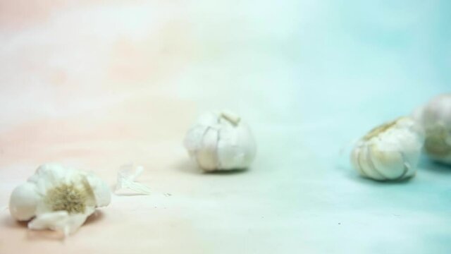 Fresh garlic rolling in slow motion and panning shot. Close-up
