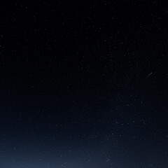 Obraz premium A starry sky with many stars and a flying meteor