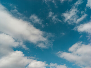 Naklejka na ściany i meble Texture of a blue sky with white clouds 