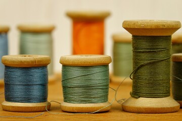 Vintage wooden spools of thread for sewing on a white background 