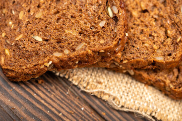 Grain bread sliced on a wooden table.