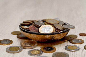 pot of coins from different countries. Real, dollar, pesos and others