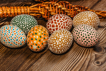 Happy Easter.Colorful hand painted decorated Easter eggs, willow branches. Handmade Easter eggs on wooden table.Spring decoration background. Festive tradition for Eastern European countries.DIY Craft