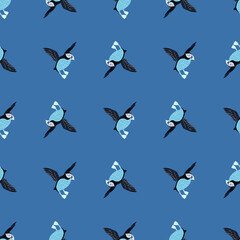 Creative seamless pattern with simple puffin bird silgouettes. Blue background. Biology zoo print.