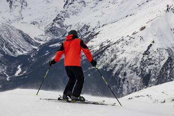 Fototapeta na wymiar Skier prepare to descend alpine slopes. Winter sports and recreation.