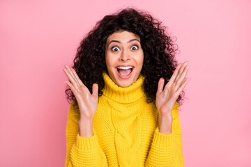 Photo of sweet impressed wavy lady dressed yellow sweater rising arms isolated pink color background