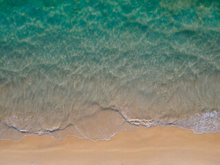 (Top view) Aerial view drone over beach sea. Beautiful sea waves. Beach sand and amazing sea. Summer sunset seascape. Phuket Thailand Beach. Water texture. Top view of the fantastic natural sunsets