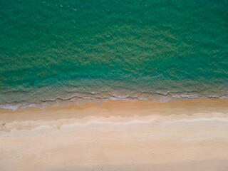 (Top view) Aerial view drone over beach sea. Beautiful sea waves. Beach sand and amazing sea. Summer sunset seascape. Phuket Thailand Beach. Water texture. Top view of the fantastic natural sunsets