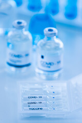 Bottle of COVOD-19 vaccine sample in a laboratory. Idea for researching and lab tests for coronavirus curing.