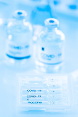 Bottle of COVOD-19 vaccine sample in a laboratory. Idea for researching and lab tests for coronavirus curing.