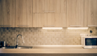 blurred kitchen interior and wooden desk space home background