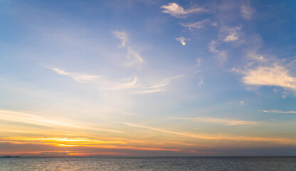 Naklejka na ściany i meble Sunset sky over sea in the evening with colorful orange sunlight cloud, Dusk sky background 