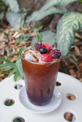 Blueberry syrup with espresso shot in a glass, placed on the table.