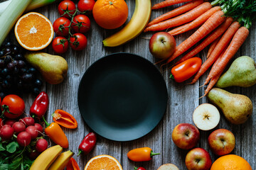 Fresh, healthy, colorful composition from various raw, seasonal fruits and vegetables, food still life on a wooden background