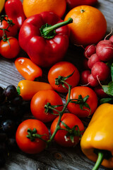 Fresh, healthy, colorful composition from various raw, seasonal fruits and vegetables, food still life on a wooden background