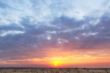 Beautiful sunset sky, plain, steppe, windmills in the distance