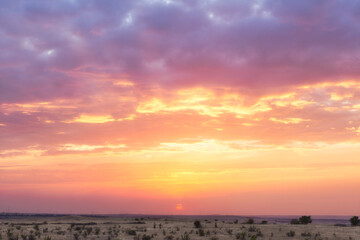 Beautiful sunset sky, plain, steppe, windmills in the distance