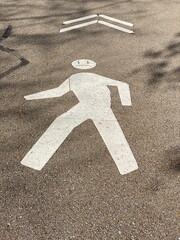 Unhappy Walking Figure Painted On Asphalt