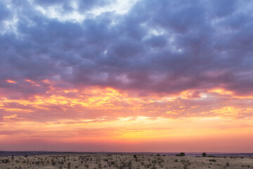 Beautiful sunset sky, plain, steppe, windmills in the distance