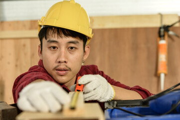 Asian young man carpenter work for customers meticulously He is a young man, a successful...