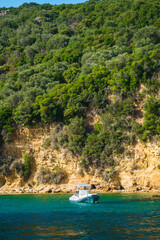 Boat in the sea. Azure water. Cliffs of the island. Greek landscapes. - 412932667