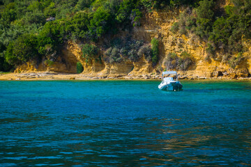Boat in the sea. Azure water. Cliffs of the island. Greek landscapes. - 412934200