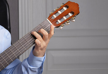 man shows guitar chords. Playing guitar close up