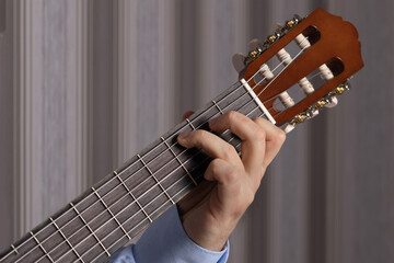 man shows guitar chords. Playing guitar close up