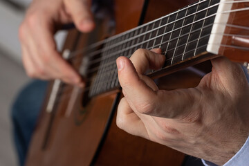man shows guitar chords. Playing guitar close up